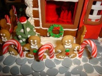 ginger bread bakery with elves inside windows